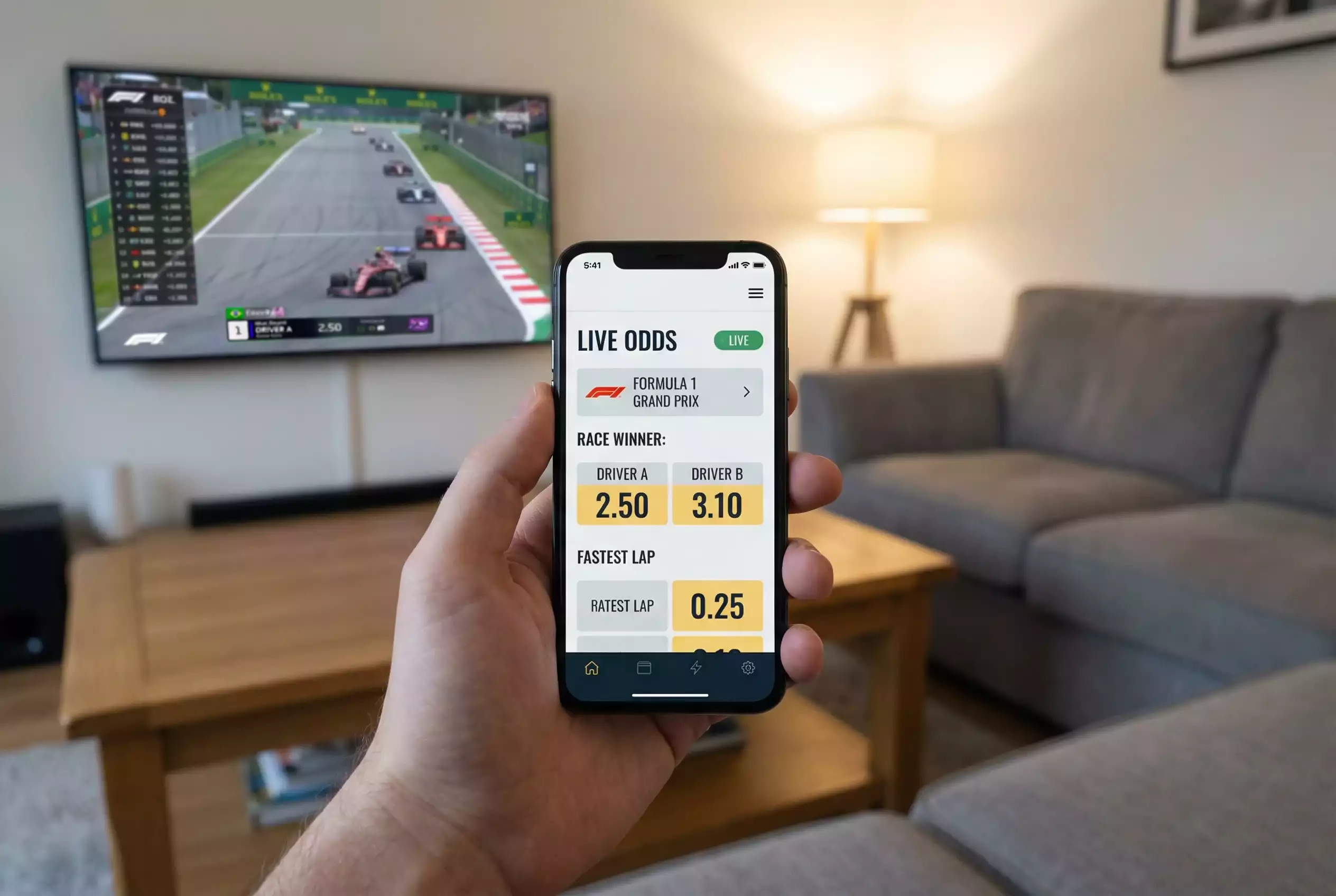Smartphone zeigt eine Wett-App während eines Formel 1 Rennens